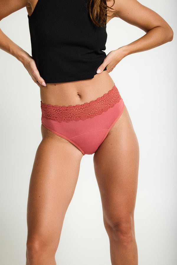 Modibodi Sensual Hi-Waist Bikini, Heavy Overnight in Rosewood Pink. Sensual Hi-Waist Bikini combines heavy flow leak-proof protection with a soft, luxe lace waistband and high leg cut. Front view.